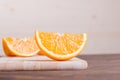 Sliced ripe appetizing delicious orange on cutting board brown t Royalty Free Stock Photo