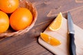 Sliced ripe appetizing delicious orange on cutting board next to Royalty Free Stock Photo