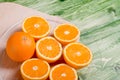 sliced ripe appetizing orange on a cutting board on a green table Royalty Free Stock Photo