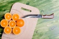 sliced ripe appetizing orange on a cutting board on a green table Royalty Free Stock Photo