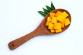 Sliced ripe mango cubes on wooden spoon on white Royalty Free Stock Photo