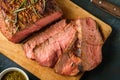 Sliced Roast beef on cutting board with grilled vegetables. Top