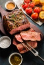 Sliced Roast beef on cutting board with grilled vegetables. Top Royalty Free Stock Photo