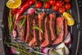 Sliced roast beef in a frying pan grill with spices and vegetables, top view Royalty Free Stock Photo