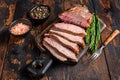 Sliced Roast beef sirloin tri tip steak bbq. Dark wooden background. Top view