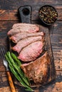 Sliced Roast beef sirloin tri tip steak bbq. Dark wooden background. Top view Royalty Free Stock Photo