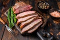 Sliced Roast beef sirloin tri tip steak bbq. Dark wooden background. Top view