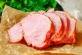 Sliced Roast Pork Loin on a brown wooden table with cilantro. Royalty Free Stock Photo