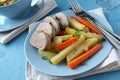 Sliced roast pork tenderloin with potatoes and carrots Royalty Free Stock Photo