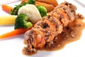 Sliced roasted boneless chicken breast with mushroom sauce on white plate