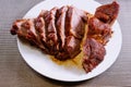 Sliced roasted meat close-up. Big piece meat on plate. Roast beef close-up. Barbecue in kitchen. Hot cooked dinner. Delicious