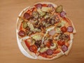 Sliced round home made pizza on plate