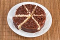 Sliced round layered sponge cake covered with chocolate glaze