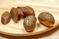 Sliced rye bread and buns sprinkled with poppy seeds