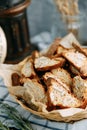 Sliced rye bread crackers with cereals. Basket with breadcrumbs on a wooden background close-up Royalty Free Stock Photo