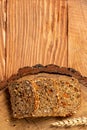 Sliced rye bread on cutting board. Whole grain rye bread with seeds of goji berry. healthy food concept. space for text. top view Royalty Free Stock Photo