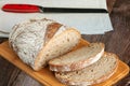 Sliced rye bread with a knife on a cutting board Royalty Free Stock Photo