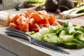 Sliced salad, tomato, cucumber and spring onion, on a wooden chopping board Royalty Free Stock Photo