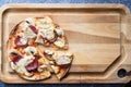 Sliced salami pizza with mozzarella cheese, white mushroom and sriracha