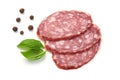 Sliced salami smoked sausage, basil leaves and peppercorns, isolated on white background Royalty Free Stock Photo