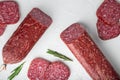Sliced salami, on white stone table background Royalty Free Stock Photo