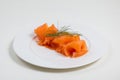 Sliced salmon with basilic beautifully placed on a plate isolated on a white background Royalty Free Stock Photo