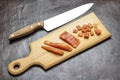 Sliced salmon on cutting board. Kitchen knife on table Royalty Free Stock Photo