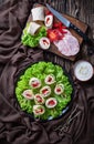 Sliced sandwich wraps on a plate, top view