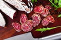 Sliced sausage fuet with herb on table Royalty Free Stock Photo