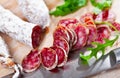 Sliced sausage fuet with herb on table Royalty Free Stock Photo