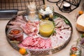 Sliced sausage, meat asorti, prosciutto and bacon with mustard sauce, can of sun-dried tomatoes Royalty Free Stock Photo