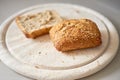 Sliced seeded wholemeal bread. Fresh brown homemade slices or roll on a wooden cutting board served as a wholesome lunch Royalty Free Stock Photo