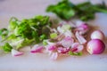 Sliced shallots with cut scallions on white cutting board Royalty Free Stock Photo