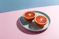 Sliced Sicilian orange on a blue plate. Creative concept of exotic fruits.