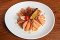 Sliced smoked salmon fillet with delicious filling, fried crackers soaked in oil, cherry tomatoes and a slice of lemon Royalty Free Stock Photo
