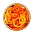 Sliced snacking mini sweet peppers, cross sections in a wooden bowl Royalty Free Stock Photo