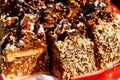 Sliced snickers cake close-up. Chocolate cake with peanuts on tray Royalty Free Stock Photo