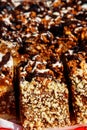 Sliced snickers cake close-up. Chocolate cake with peanuts on a tray Royalty Free Stock Photo