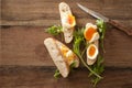 Sliced soft boiled eggs on fresh baguette Royalty Free Stock Photo