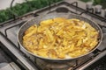 Sliced Spanish potato omelette in pan, selective focus. Potato Egg and Onion Omelette known locally as an Spanish Tortilla. It is