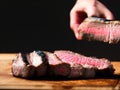 sliced steak on a chopping board studio background