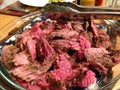 Sliced steak, rare, on a platter