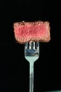 sliced steaks impaled on meat fork Royalty Free Stock Photo