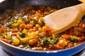 Sliced stewed colorful vegetables on frying pan