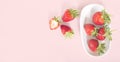 Sliced strawberry and strawberry bowl on pink background Royalty Free Stock Photo