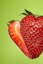 Sliced strawberry on green background