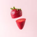 Sliced strawberry on pastel pink background. Minimal fruit concept Royalty Free Stock Photo