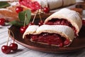 Sliced strudel with cherry close-up on a plate. horizontal Royalty Free Stock Photo