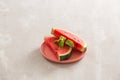 Sliced sweet red watermelon pieces on a plate centered on table Royalty Free Stock Photo