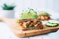 sliced tempeh sandwich with cucumber and sprouts on sourdough